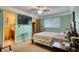 Relaxing bedroom features a doorway to bathroom, closet and a television mounted on the wall at 2368 Ellis Court, Snellville, GA 30078