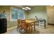 Cozy dining area features natural light and a four-chair wooden table set, perfect for Gathering meals at 2368 Ellis Court, Snellville, GA 30078
