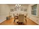 Cozy dining room featuring a round table, four chairs, chandelier, and wainscoting, perfect for Gathering meals at 2368 Ellis Court, Snellville, GA 30078