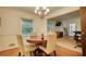 Bright dining area featuring hardwood floors, a chandelier, and large windows with a view to the front yard at 2368 Ellis Court, Snellville, GA 30078