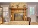 Elaborate wood trim adorns the brick fireplace with glass enclosure adding charm to the living space at 2368 Ellis Court, Snellville, GA 30078