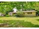 Welcoming one-story home with beautiful landscaping, lush green lawn and mature trees for outdoor enjoyment at 2368 Ellis Court, Snellville, GA 30078