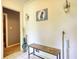 Hallway featuring tile flooring, a bench with wrought iron legs, and decorative wall sconces at 2368 Ellis Court, Snellville, GA 30078