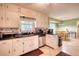 Kitchen with light cabinets, black countertops, stainless steel appliances, and open dining area at 2368 Ellis Court, Snellville, GA 30078