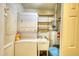 Functional laundry room with washer, dryer, utility sink, and storage shelves at 2368 Ellis Court, Snellville, GA 30078