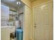 A functional laundry room featuring a washer, dryer, water heater, and convenient storage shelves at 2368 Ellis Court, Snellville, GA 30078