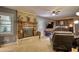 Living room with brick fireplace, ceiling fan, mounted television, and comfortable seating at 2368 Ellis Court, Snellville, GA 30078