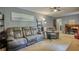 Comfortable living room featuring neutral carpet, a grey sofa, and a reading area at 2368 Ellis Court, Snellville, GA 30078