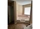 Bathroom with a garden tub, pink tile accents, and natural light at 432 Manor Estates Dr, Stockbridge, GA 30281