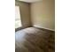 The bedroom boasts wood-look flooring and a window providing natural light at 432 Manor Estates Dr, Stockbridge, GA 30281