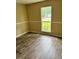 This bedroom features wood-look flooring and a window offering outdoor views at 432 Manor Estates Dr, Stockbridge, GA 30281