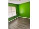 Cozy bedroom with light-filled window, sleek floors, and eye-catching green paint at 432 Manor Estates Dr, Stockbridge, GA 30281