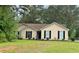 Charming single-story home featuring manicured lawn and classic curb appeal with mature trees at 432 Manor Estates Dr, Stockbridge, GA 30281