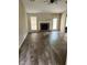 Spacious living room features a brick fireplace, modern ceiling fan, and beautiful wood floors at 432 Manor Estates Dr, Stockbridge, GA 30281