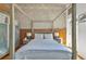 Spacious bedroom with a four-poster bed, concrete block wall, and ample natural light at 542 Ralph Mcgill Ne Blvd # 7, Atlanta, GA 30312