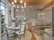 Cozy dining room with stylish chandelier, exposed beam, exposed concrete block and window views at 542 Ralph Mcgill Ne Blvd # 7, Atlanta, GA 30312