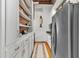 Galley kitchen featuring white cabinets, exposed brick accents, and stainless steel refrigerator at 542 Ralph Mcgill Ne Blvd # 7, Atlanta, GA 30312