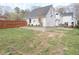 Backyard featuring a retaining wall and partially fenced yard at 762 Thompson Ln, Loganville, GA 30052