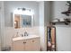 Bathroom featuring a vanity with a marble countertop, modern fixtures, and decorative shelves at 762 Thompson Ln, Loganville, GA 30052