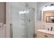 Bright bathroom featuring a glass enclosed shower, vanity with a marble countertop, and a modern light fixture at 762 Thompson Ln, Loganville, GA 30052