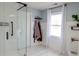 Bathroom with glass enclosed shower, wainscoting, and white trim at 762 Thompson Ln, Loganville, GA 30052