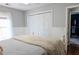 Spacious bedroom featuring a large bed with a soft blanket and a closet with bi-fold doors at 762 Thompson Ln, Loganville, GA 30052