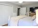 Comfortable bedroom with a cozy bed and bedside table, storage, and access to other rooms at 762 Thompson Ln, Loganville, GA 30052