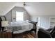 Attic bedroom featuring a large window, built-in shelves, and hardwood floors at 762 Thompson Ln, Loganville, GA 30052