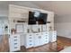 Bedroom with a large built-in shelving and cabinet system with a mounted television at 762 Thompson Ln, Loganville, GA 30052