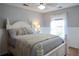 Cozy bedroom with a large bed, wood floors, decorative pillows, and natural light from the window at 762 Thompson Ln, Loganville, GA 30052