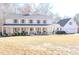 Charming two-story home with a welcoming front porch and manicured landscaping at 762 Thompson Ln, Loganville, GA 30052