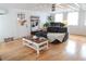 Bright living room featuring hardwood floors, a sectional sofa, a decorative coffee table, and ample natural light at 762 Thompson Ln, Loganville, GA 30052
