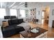Bright living room with hardwood floors, a comfortable sectional sofa, and large windows for natural light at 762 Thompson Ln, Loganville, GA 30052