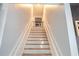 Stairway with wood stairs and white risers leads to the upper level of the home at 762 Thompson Ln, Loganville, GA 30052