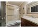 Bathroom featuring glass-enclosed tiled shower, granite vanity, and chrome fixtures at 9056 Riverbend Mnr, Alpharetta, GA 30022