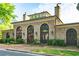 Clubhouse exterior with arched windows, brick facade, and professionally manicured landscaping at 9056 Riverbend Mnr, Alpharetta, GA 30022
