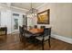 Dining room showcasing a wooden table and a modern chandelier for a cozy Gathering space at 9056 Riverbend Mnr, Alpharetta, GA 30022