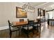 Dining room featuring dark wood table, seating for six and view of kitchen at 9056 Riverbend Mnr, Alpharetta, GA 30022
