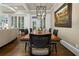 Open dining room with a large wooden table and stylish lighting fixture, adjacent to living area at 9056 Riverbend Mnr, Alpharetta, GA 30022