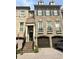 Charming brick townhome with front-entry garage and well-maintained landscaping at 9056 Riverbend Mnr, Alpharetta, GA 30022