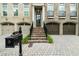 Inviting townhouse with brick facade, featuring a charming entryway and front lawn at 9056 Riverbend Mnr, Alpharetta, GA 30022