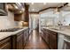 Gourmet kitchen showcasing dark wood cabinets, granite countertops, and stainless steel appliances at 9056 Riverbend Mnr, Alpharetta, GA 30022