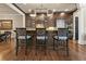 Kitchen island features dark wood cabinetry, granite countertops, and barstool seating at 9056 Riverbend Mnr, Alpharetta, GA 30022