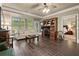 Spacious living room with desk area, comfortable seating, and view to a bedroom at 9056 Riverbend Mnr, Alpharetta, GA 30022
