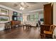Well-lit living room with decorative ceiling fan, media center, and comfortable seating at 9056 Riverbend Mnr, Alpharetta, GA 30022