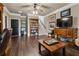 Inviting living room with shelving, tv, and seating area enhanced by wood-look flooring at 9056 Riverbend Mnr, Alpharetta, GA 30022