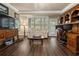 Comfortable living room featuring a media center, desk area, and neutral tones at 9056 Riverbend Mnr, Alpharetta, GA 30022