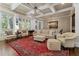 Elegant living room featuring coffered ceilings, large windows, and a classic area rug at 9056 Riverbend Mnr, Alpharetta, GA 30022