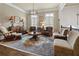 Cozy living room featuring a patterned rug, elegant lighting, and comfortable seating arrangements at 9056 Riverbend Mnr, Alpharetta, GA 30022