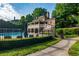 Community pool with lounge chairs, second-story patio, lush landscaping and perimeter fence at 9056 Riverbend Mnr, Alpharetta, GA 30022
